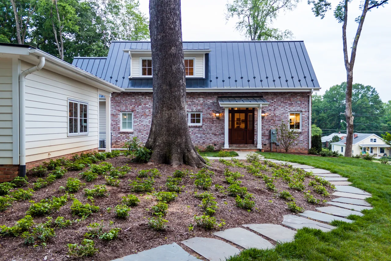 Entrance of the house with flagstone walkway and plants