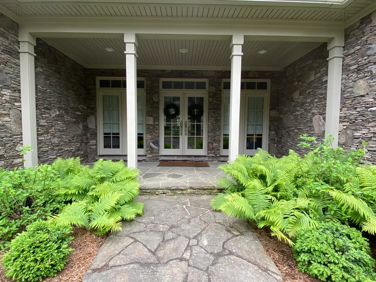 Flagstone path and ferns leading to the front entry porch